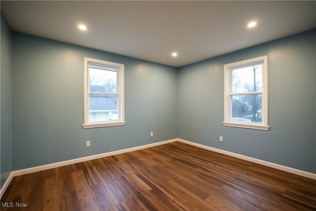 unfurnished room featuring dark hardwood / wood-style flooring