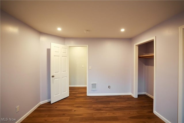 unfurnished bedroom with dark hardwood / wood-style floors