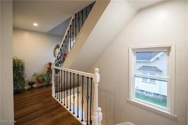 staircase with hardwood / wood-style flooring and lofted ceiling