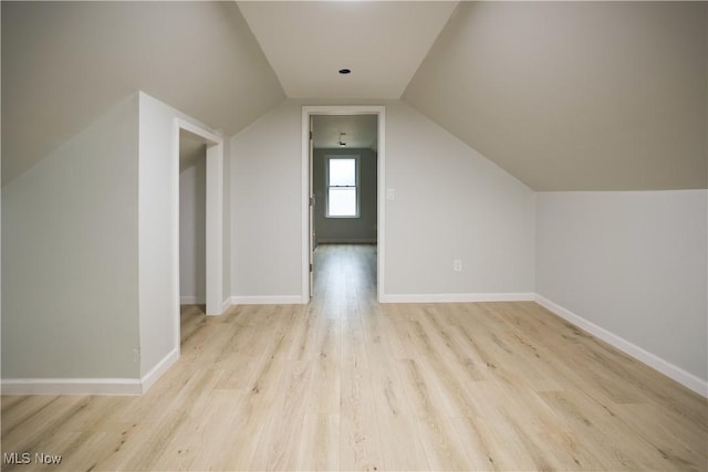 bonus room featuring vaulted ceiling and light wood-type flooring