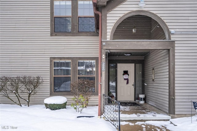 view of snow covered property entrance