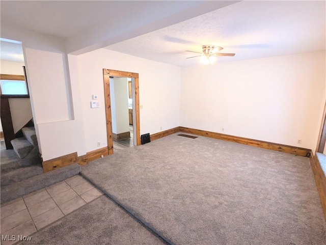 empty room with tile patterned floors and ceiling fan