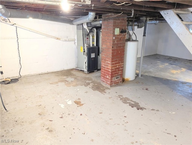 basement featuring water heater and heating unit