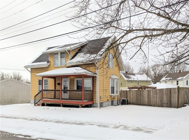 snow covered property with a wooden deck