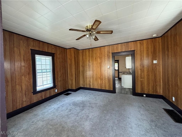 unfurnished room featuring dark carpet and ceiling fan