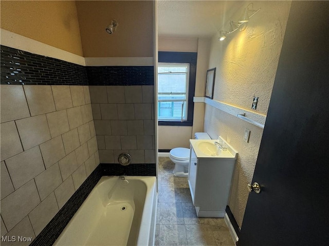 bathroom featuring vanity, toilet, and a bathing tub