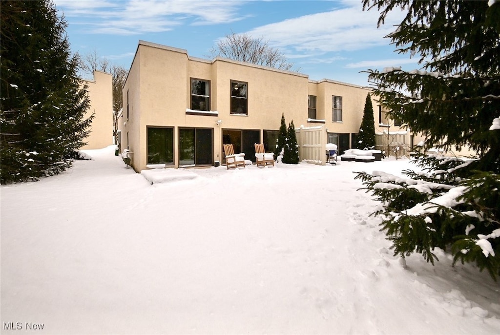 view of snow covered rear of property