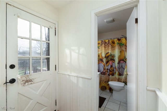 bathroom with tile patterned flooring and toilet