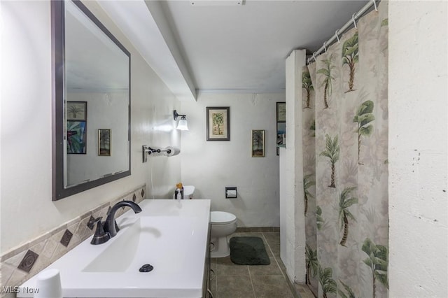 bathroom with tile patterned flooring, toilet, and sink