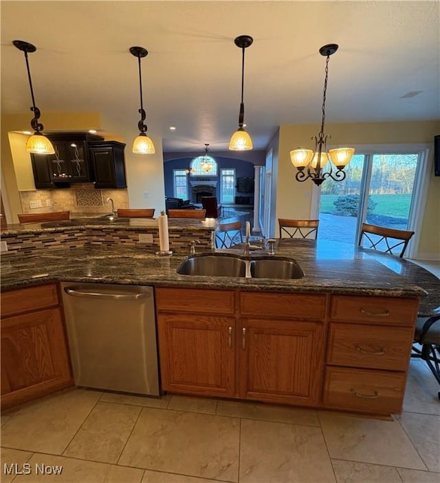 kitchen featuring pendant lighting, stainless steel dishwasher, a notable chandelier, and sink