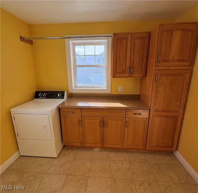 laundry room featuring washer / clothes dryer and cabinets