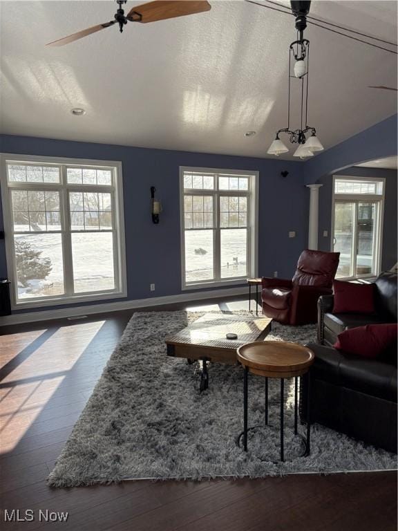 living room with wood-type flooring, ceiling fan, and lofted ceiling