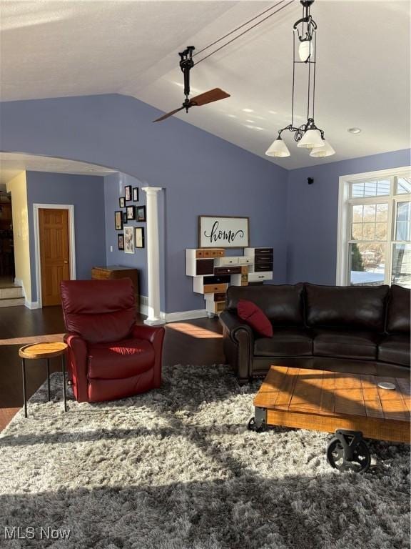 living room with wood-type flooring, vaulted ceiling, and ceiling fan