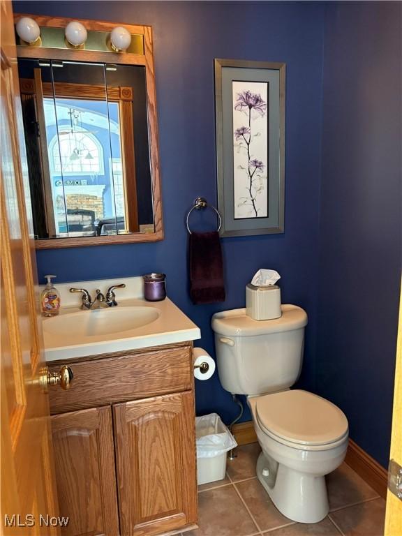 bathroom featuring tile patterned floors, vanity, and toilet