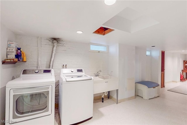 laundry room featuring washer and clothes dryer and sink