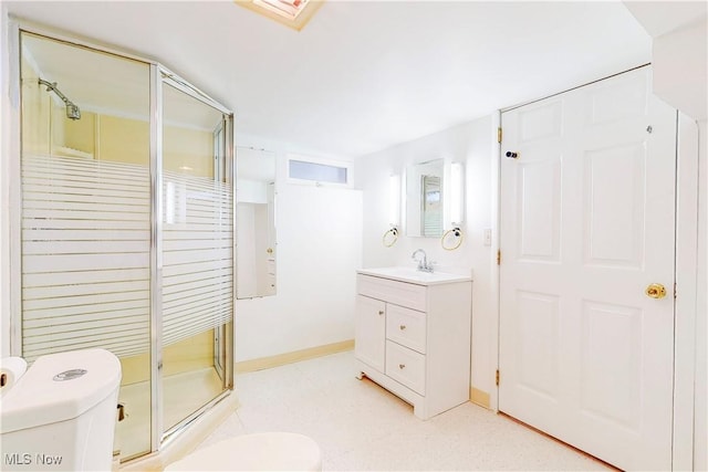 bathroom with a shower with door, vanity, and toilet