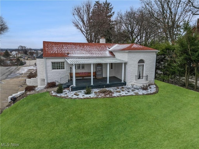 back of house with a sunroom and a lawn