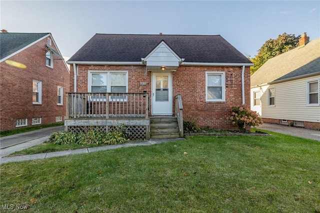 bungalow-style home with a front yard