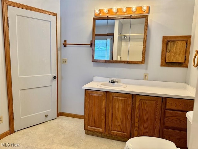 bathroom featuring vanity and toilet