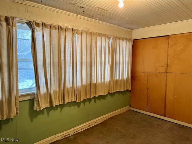 unfurnished bedroom with multiple windows, a closet, and dark colored carpet