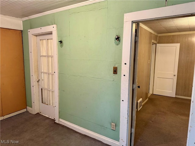 corridor featuring crown molding and dark colored carpet