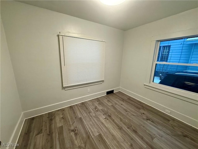 spare room with hardwood / wood-style floors