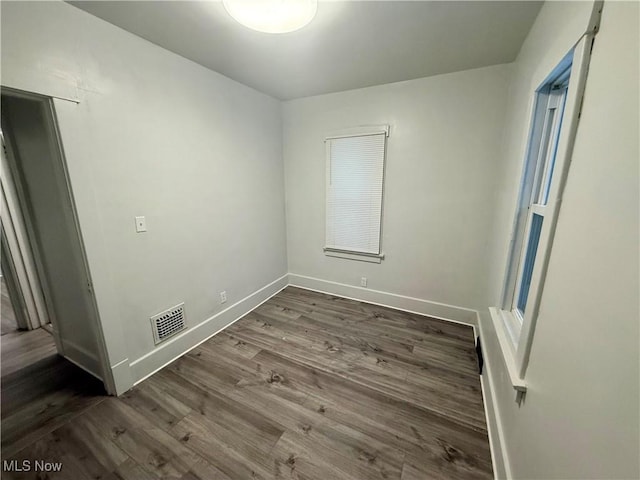 unfurnished room featuring dark hardwood / wood-style flooring