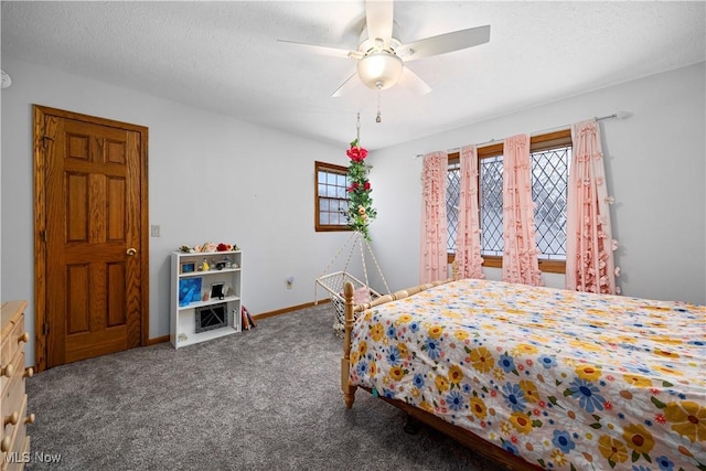 bedroom with baseboards, carpet floors, a textured ceiling, and a ceiling fan