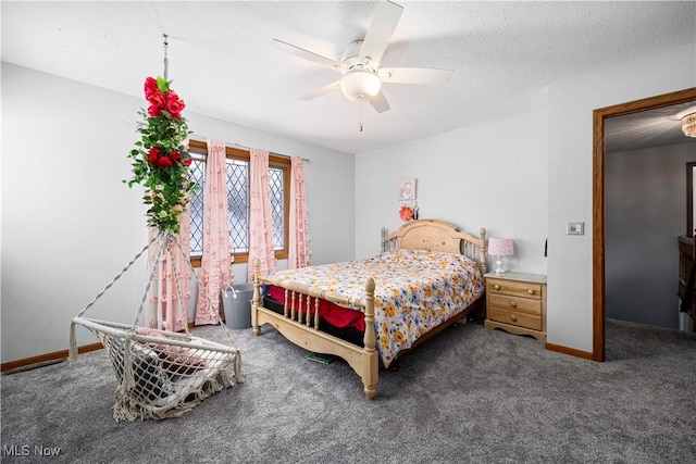 carpeted bedroom with ceiling fan and a textured ceiling