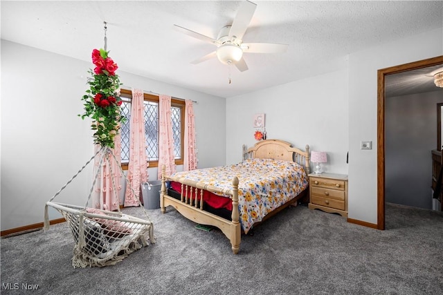 carpeted bedroom with ceiling fan, baseboards, and a textured ceiling