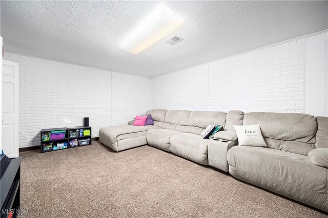 living room featuring a textured ceiling, brick wall, and carpet