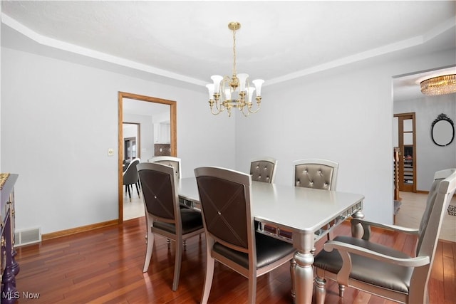 dining room featuring dark hardwood / wood-style floors and a chandelier