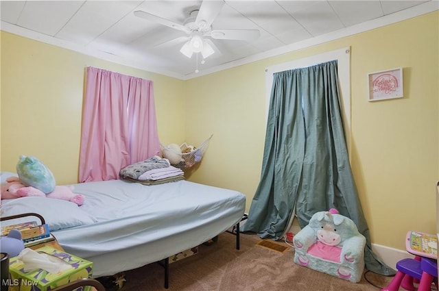 bedroom featuring carpet flooring, ceiling fan, and crown molding