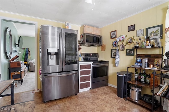 kitchen with ornamental molding, stainless steel appliances, and light carpet