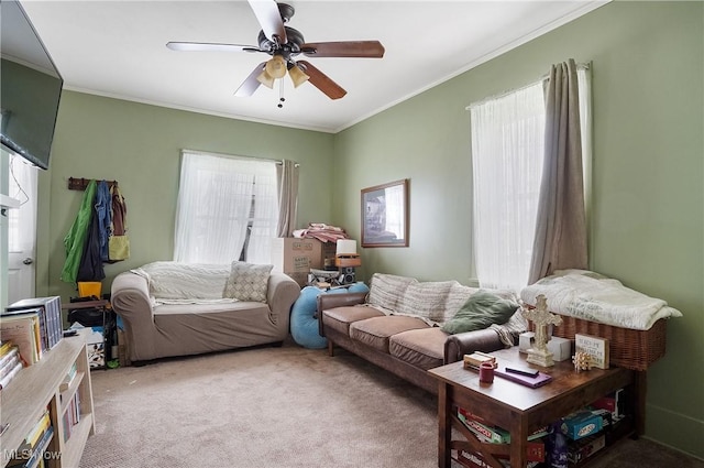 carpeted living room featuring ceiling fan, a healthy amount of sunlight, and ornamental molding