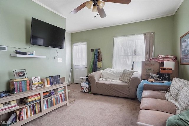 living room featuring light carpet, ceiling fan, and ornamental molding