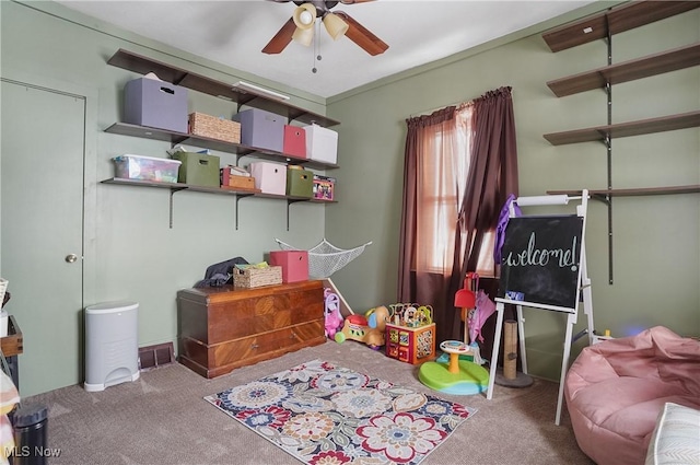 interior space featuring light carpet and ceiling fan