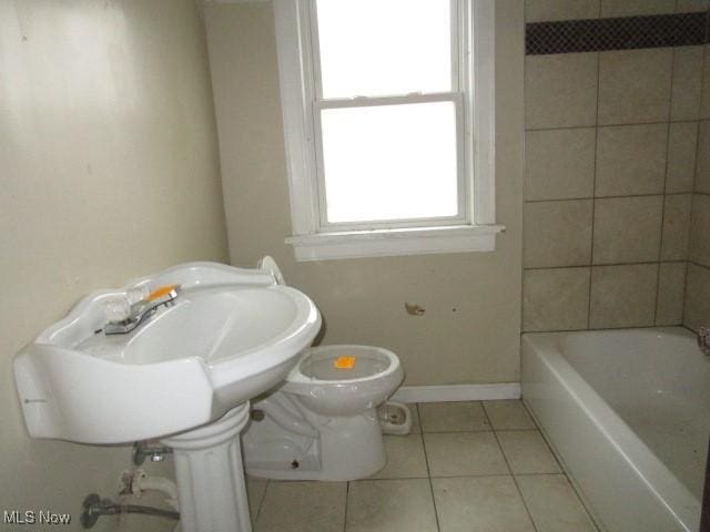 bathroom with toilet and tile patterned floors