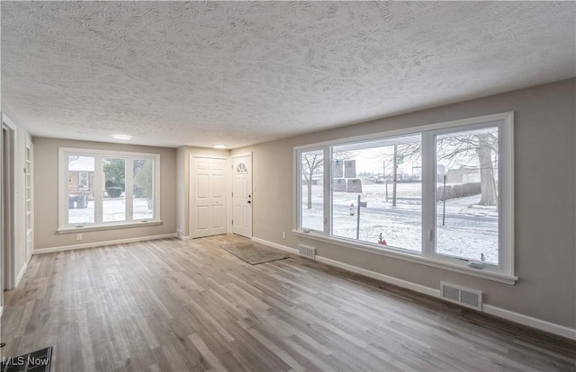 interior space with light hardwood / wood-style flooring and a textured ceiling