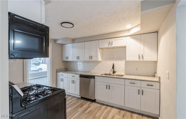 kitchen featuring black appliances, white cabinets, sink, light hardwood / wood-style flooring, and light stone counters