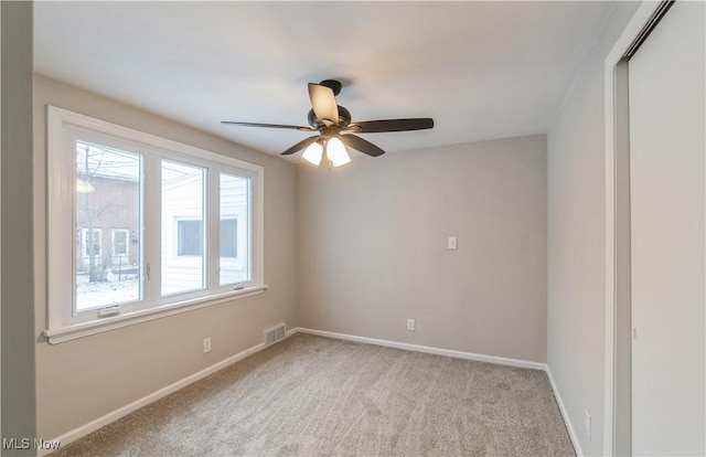 carpeted empty room with ceiling fan