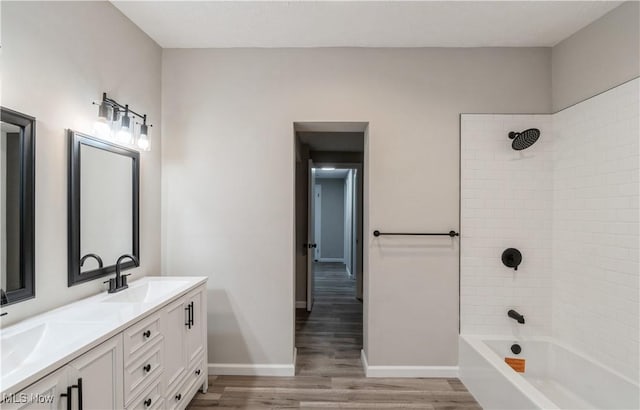 bathroom featuring vanity, hardwood / wood-style flooring, and tiled shower / bath