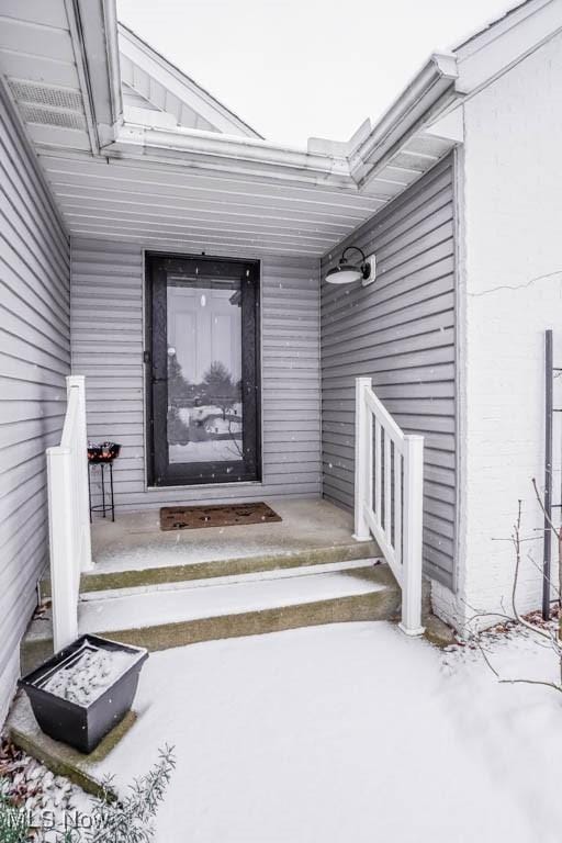 view of snow covered property entrance