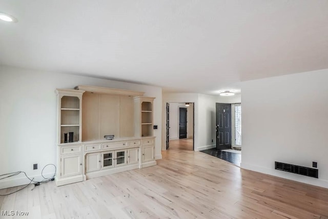 unfurnished living room featuring light wood-type flooring