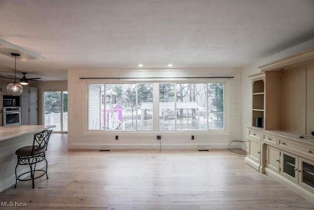 living room with a healthy amount of sunlight and light wood-type flooring