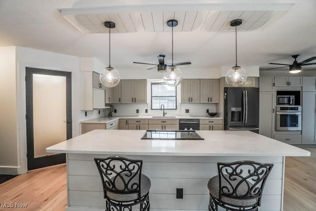 kitchen featuring light hardwood / wood-style floors, gray cabinets, sink, and black appliances