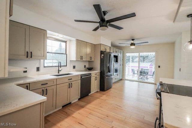 kitchen featuring plenty of natural light, sink, pendant lighting, and black appliances