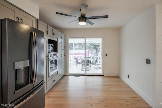 kitchen with stainless steel appliances, ceiling fan, gray cabinets, and light hardwood / wood-style floors