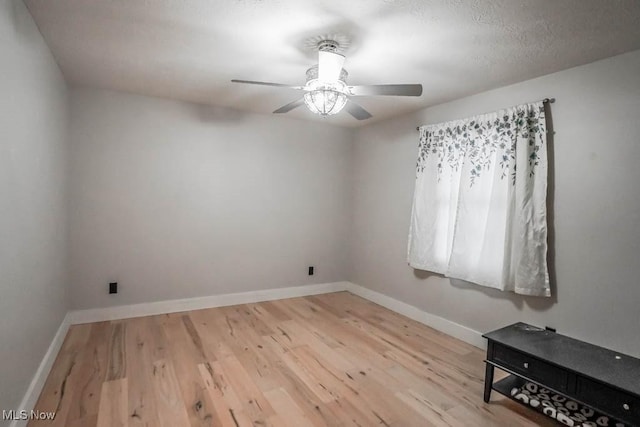 unfurnished room featuring ceiling fan and light hardwood / wood-style floors