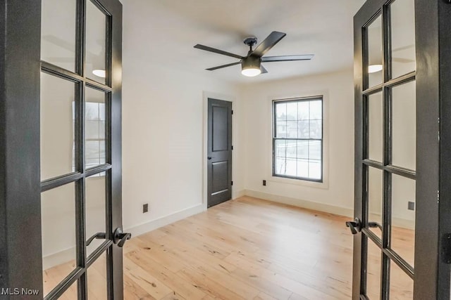 spare room featuring ceiling fan, light hardwood / wood-style floors, and french doors